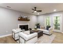 Bright living room with a fireplace, contemporary seating, and access to outdoor patio at 103 Summerlin Dr Dr, Chapel Hill, NC 27514