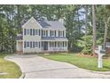 Inviting two-story home with a classic design, a well-kept lawn, and a welcoming atmosphere in a leafy setting at 106 Rock Nest Ct, Morrisville, NC 27560