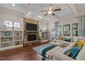 Inviting living room with a stone fireplace, built-in shelves, hardwood floors, and ample natural light at 12216 Kyle Abbey Ln, Raleigh, NC 27613