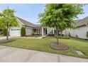 Charming home with a well-manicured lawn, two-car garage, and lovely landscaping at 123 Turnstone Dr, Durham, NC 27703