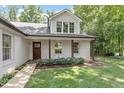Inviting entrance featuring wood pillars and a beautifully stained wooden front door at 124 Lord Ashley Rd, Raleigh, NC 27610