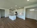 Open-concept kitchen boasting white cabinets, stainless steel appliances, granite countertops, and an island at 125 Fraiser Fir Way, Lillington, NC 27546