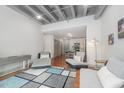 Bright living room with hardwood floors, a stylish rug, and modern chaise lounges at 1300 St Marys St # 408, Raleigh, NC 27605