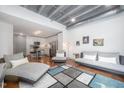 Open-concept living room with modern furnishings and hardwood floors leading to the kitchen at 1300 St Marys St # 408, Raleigh, NC 27605