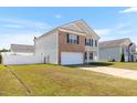Beautiful home with a well-maintained lawn and attached two-car garage at 131 Botanical Ct, Bunnlevel, NC 28323