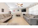 Comfortable living room with a fireplace, ceiling fan, and lots of seating at 131 Botanical Ct, Bunnlevel, NC 28323