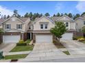 Attractive two-story townhouses featuring brick accents and attached garages in a well-maintained community at 1413 Glenwater Dr, Cary, NC 27519