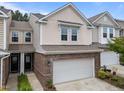 Lovely two-story townhouse with a brick front and a convenient two-car attached garage at 1413 Glenwater Dr, Cary, NC 27519