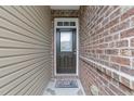 Welcoming front door with glass insert, complemented by brick and siding, for an inviting entryway at 1413 Glenwater Dr, Cary, NC 27519