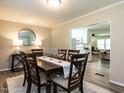 Elegant dining room with a wood table set for six, soft lighting, and an open layout at 1612 Bethlehem Rd, Knightdale, NC 27545