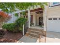 Welcoming front porch with stone steps, cozy decor, and a charming entrance at 1612 Old Bramble Ln, Fuquay Varina, NC 27526