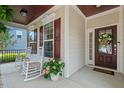 Relaxing front porch with rocking chairs, stylish decor, and a welcoming entrance at 1612 Old Bramble Ln, Fuquay Varina, NC 27526