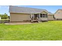 Spacious backyard featuring a patio area, a screened in porch, and plenty of lush green grass at 191 Bridle Dr, Angier, NC 27501