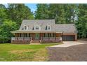 Beautiful brick home with a covered front porch, dormer windows, and attached two-car garage at 2015 Saddlebrook Dr, Archer Lodge, NC 27527