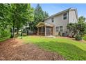 Spacious backyard features a screened porch, lush greenery, and mature trees at 2018 Remington Oaks Cir, Cary, NC 27519