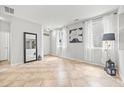 Bright living room with tile flooring, neutral paint, and abundant natural light at 2018 Remington Oaks Cir, Cary, NC 27519