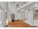 Spacious open foyer with hardwood floors, a staircase, and a view of the upper level at 2224 Narrawood St, Raleigh, NC 27614