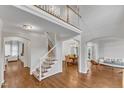 Open-concept living space with hardwood floors, staircase, and view to dining room at 2224 Narrawood St, Raleigh, NC 27614