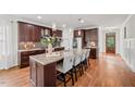 Gourmet kitchen with stainless steel appliances, granite countertops, and a large center island with seating at 2256 Toad Hollow Trl, Apex, NC 27502