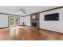 Comfortable living room with a brick fireplace, ceiling fan, and access to outdoor deck at 2708 Halfhitch Trl, Raleigh, NC 27615