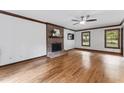 Spacious living room featuring a brick fireplace, hardwood floors, and natural light from the windows at 2708 Halfhitch Trl, Raleigh, NC 27615