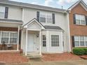 Charming townhouse featuring a covered entryway, bay window, and a mix of siding and brick facade at 2845 Bennington Dr, Clayton, NC 27520
