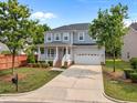 Attractive two-story home with an attached garage and a well-manicured lawn on a sunny day at 324 Farrow Glen Loop, Cary, NC 27519