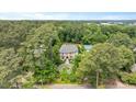 Estate home surrounded by mature trees with tennis court, pristine landscaping, and circular driveway at 3347 Alamance Dr, Raleigh, NC 27609