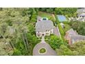 Luxury home with manicured lawn, swimming pool, tennis court, and circular driveway at 3347 Alamance Dr, Raleigh, NC 27609