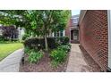 Close up of the front walkway with decorative bushes and plants leading to the front door of a brick house at 3408 Mount Pisgah Way, Cary, NC 27519