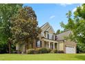 Beautiful home exterior with lush landscaping, mature trees, and a well-maintained lawn at 37 Meadow Oaks Cir, Smithfield, NC 27577