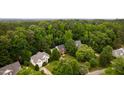 Aerial view of a home nestled among mature trees in a tranquil neighborhood at 3908 Sterling Ridge Ln, Durham, NC 27707