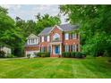 Attractive brick home with a well-maintained lawn and classic black shutters at 3908 Sterling Ridge Ln, Durham, NC 27707