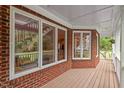 Stylish front porch with brick accents, offering view into the home's interior at 3912 Kildrummy Dr, Durham, NC 27705