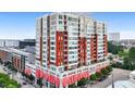 Exterior view of multi-story condominium building with red awnings in the city at 400 W North St # 604, Raleigh, NC 27603