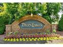 Brick community sign with 'Twin Lakes' displayed in gold lettering at 407 Elm Farm Pl, Morrisville, NC 27560