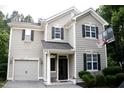 Two-story home featuring a garage and a basketball hoop at 407 Elm Farm Pl, Morrisville, NC 27560