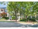 Charming townhomes line the street with beautiful landscaping and mature trees in a well-maintained neighborhood at 408 Heritage Village Ln, Apex, NC 27502