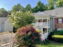 Charming condo building featuring lovely landscaping, and quaint walkway and staircases at 411 Gooseneck Dr # A1, Cary, NC 27513