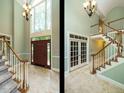 Spacious foyer with soaring ceilings, tiled floors, and a grand staircase at 4204 Thetford Rd, Durham, NC 27707