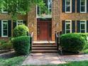 Inviting front entrance featuring a brick walkway and well-maintained landscaping at 4204 Thetford Rd, Durham, NC 27707