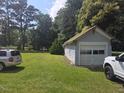 Detached garage with roll-up door located on a well-maintained lawn, offering ample parking at 500 W Main St, Benson, NC 27504