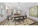Formal dining room with a large wooden table, chandelier, and elegant decor at 504 Yarmouth Rd, Raleigh, NC 27608