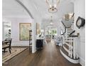 Elegant foyer with hardwood floors, white trim, staircase, and decorative lighting fixtures at 504 Yarmouth Rd, Raleigh, NC 27608