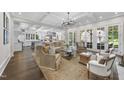 Spacious living room with hardwood floors, coffered ceilings, and French doors leading to the outside at 504 Yarmouth Rd, Raleigh, NC 27608