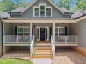 Welcoming front entrance with a covered porch and manicured landscaping leading to the front door at 5300 Langdon Dr, Oxford, NC 27565