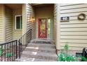 Close up of the front door and steps of a home featuring a red door and a black railing at 60 Stoneridge Rd, Durham, NC 27705