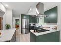 Modern kitchen features sleek appliances, white countertops, and chic green cabinets at 60 Stoneridge Rd, Durham, NC 27705