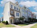 Attractive row of multi-story townhomes with unique exterior designs and landscaping at 601 Grand Central Sta, Apex, NC 27502