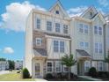 Beautiful multi-story townhome with stone accents and an inviting entrance at 601 Grand Central Sta, Apex, NC 27502